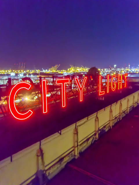 Neon sign above a building saying 