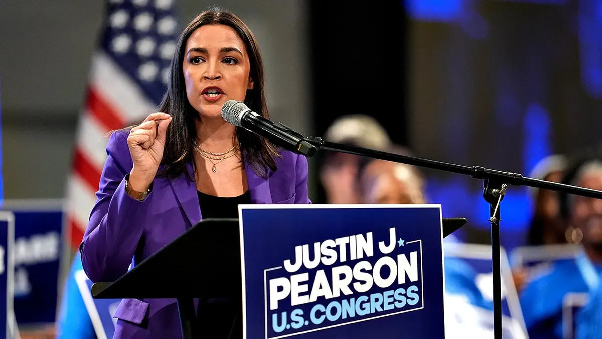 Alexandra Ocasio Cortez speaking at a podium.
